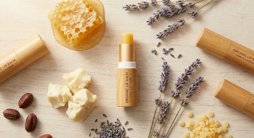 Premium bamboo lip balm tube displayed with natural organic ingredients.