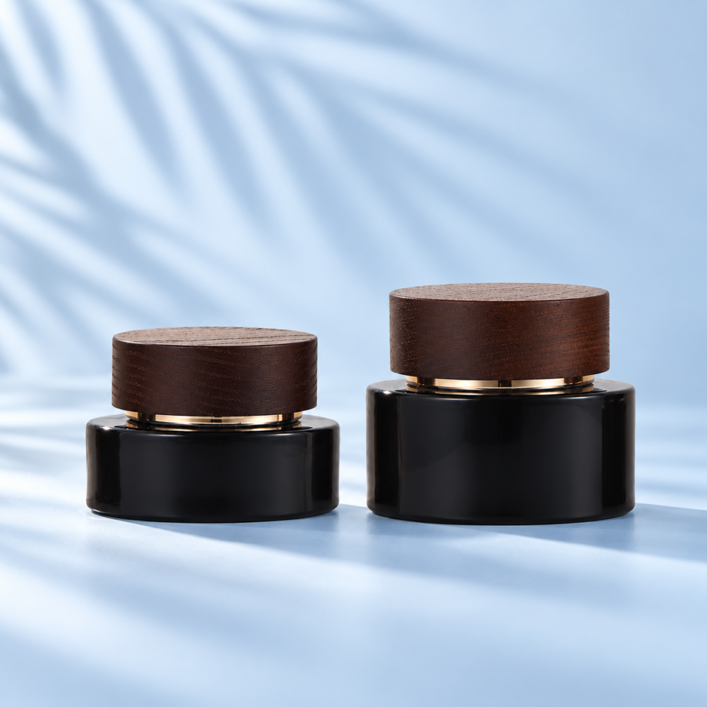 30g and 50g black glass cosmetic cream jars with dark solid wood lids on a pale blue background