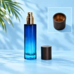 Blue gradient spray bottle and dark wood cap on a cyan tabletop, with a separate framed cap interior detail