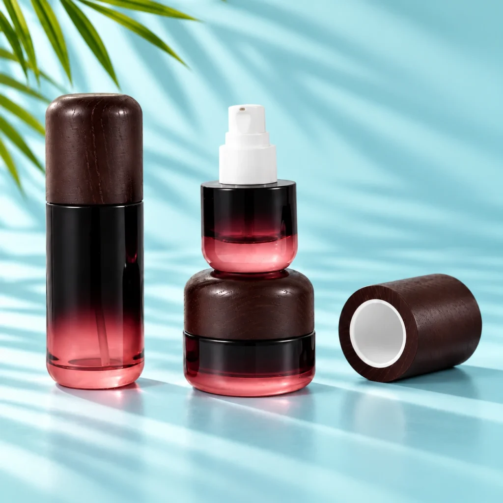 Burgundy gradient glass bottle with dark wood cap, exposed white pump and matching cream jar on a light cyan tabletop with visible green palm leaves