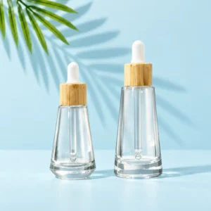 Clear tapered glass dropper bottle samples with bamboo collars and white bulbs