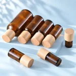 Amber glass essential oil bottles with natural wood caps laid out together
