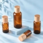 Amber glass essential oil bottles with wood caps in a group display