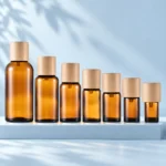 Seven amber glass essential oil bottles with natural wood caps arranged by size